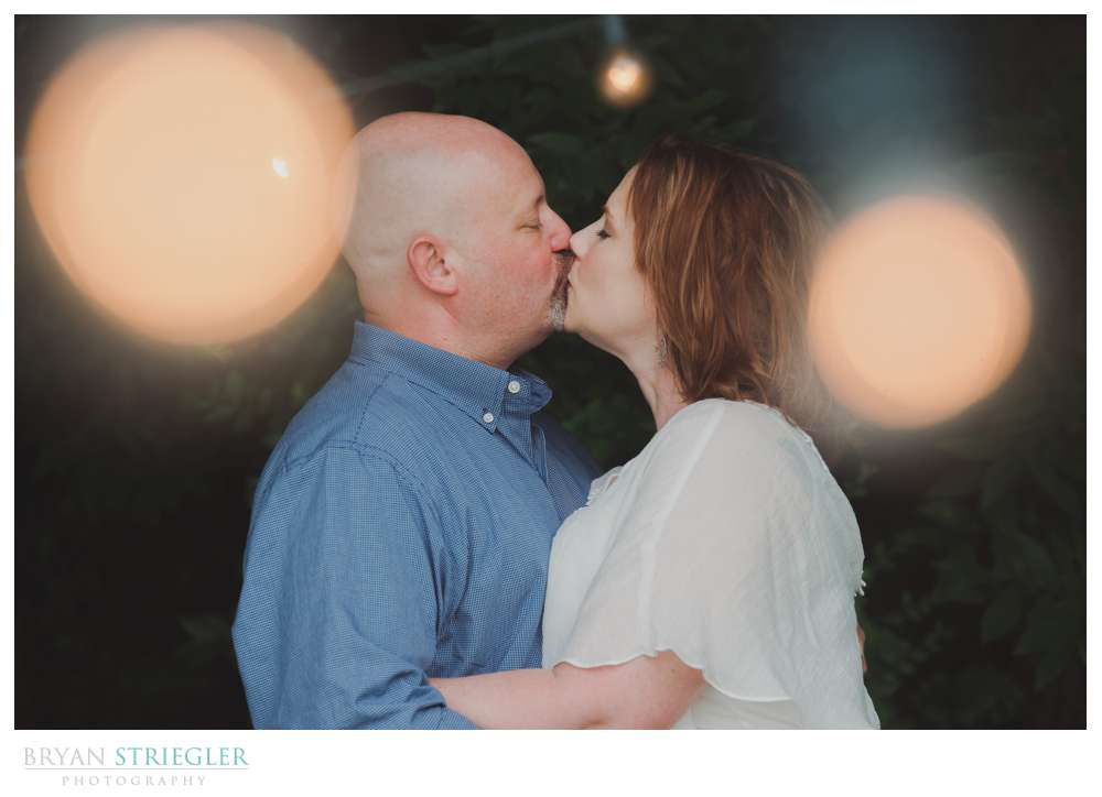 kissing with twinkle lights around them